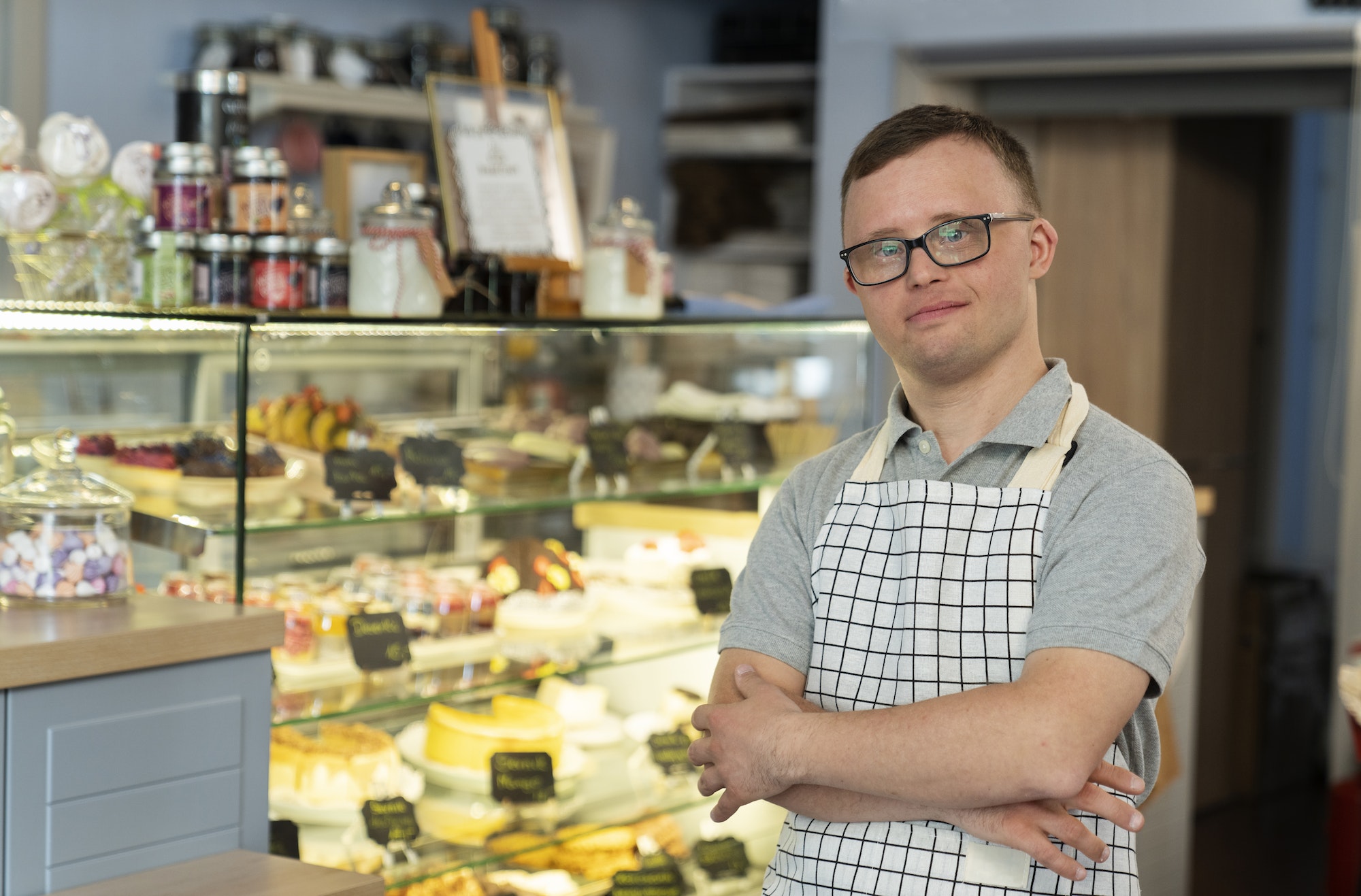 Portrait of caucasian man with down syndrome working in the cafe